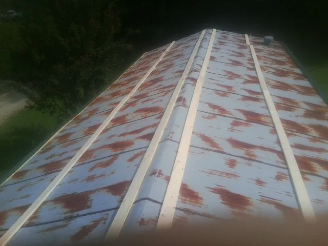 Rusted metal roof panels with new wood purlins before replacement — Storm Damage Roof Repair in Armour by Roofing Brothers